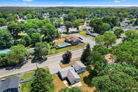 an aerial view of a house with yard