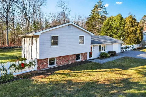 a view of a house with pool and a yard