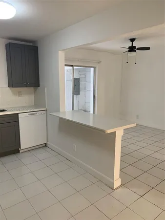 a kitchen with stainless steel appliances a refrigerator and a cabinets
