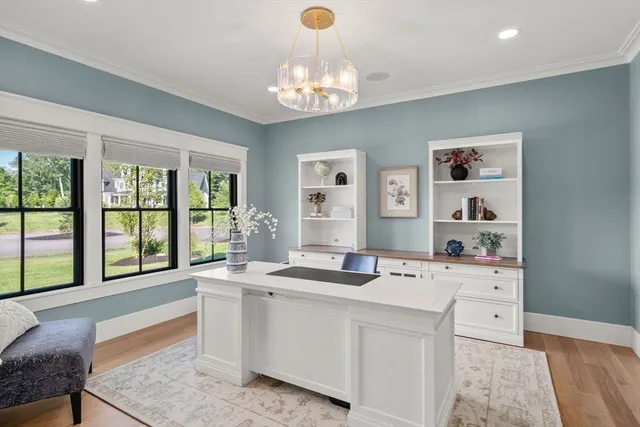 a room with kitchen island and large windows