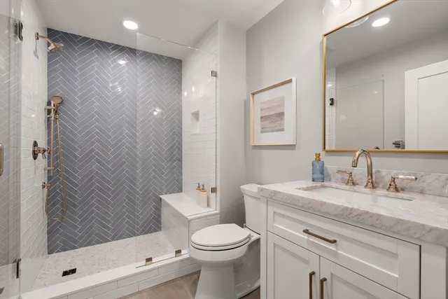 a bathroom with a sink toilet and shower