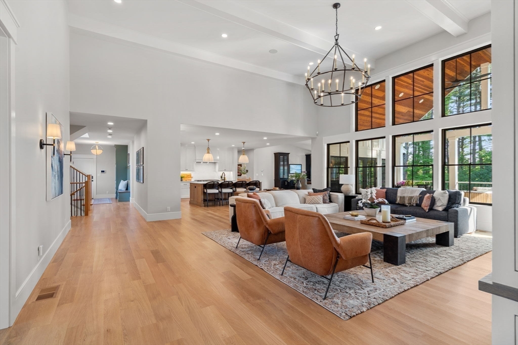 12 Ariana Lane Norfolk, MA 02056 - Photo 21 of 41 a living room with furniture a chandelier and wooden floor