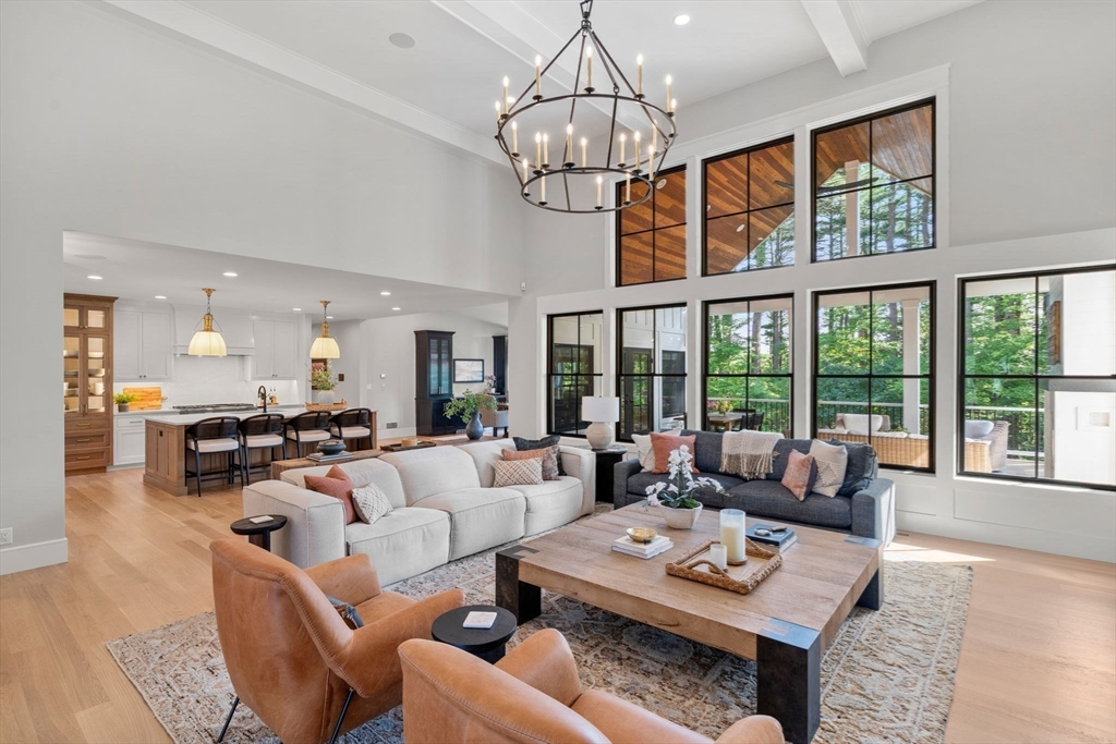 12 Ariana Lane Norfolk, MA 02056 - Photo 3 of 41 a living room with furniture a chandelier and a dining table
