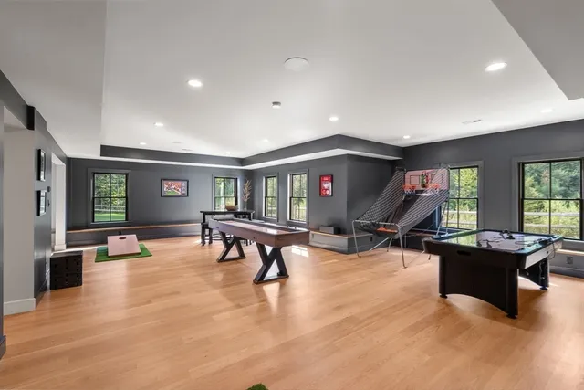 a living room with furniture pool table and a large window