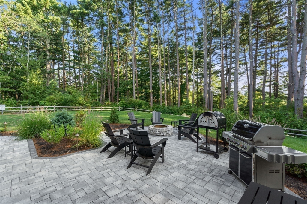 12 Ariana Lane Norfolk, MA 02056 - Photo 39 of 41 a view of a patio with table and chairs potted plants and a large tree