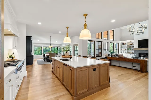 a kitchen with stainless steel appliances a sink stove and cabinets