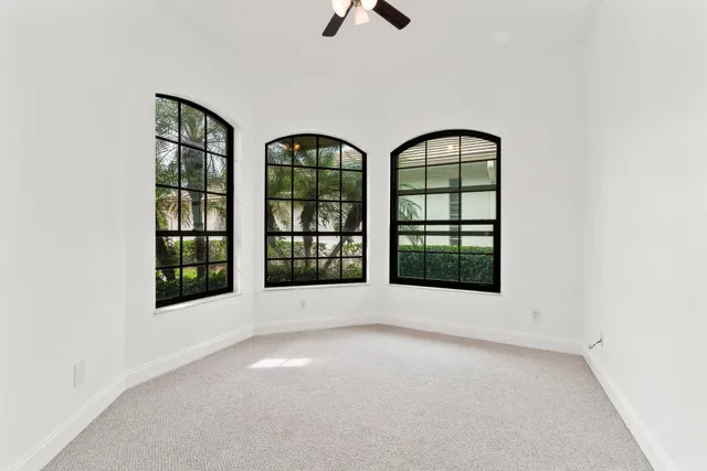 an empty room with windows and entrance