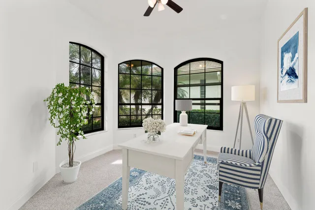 a living room with furniture a chandelier and a large window