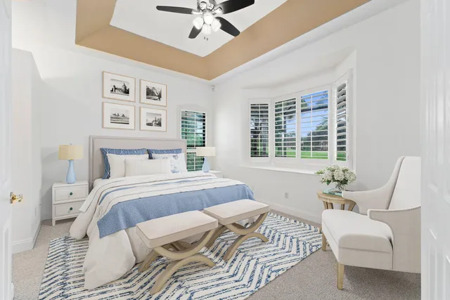 a bedroom with a large bed couch and a window