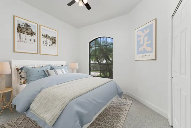 a bedroom with a bed and a painting on the wall