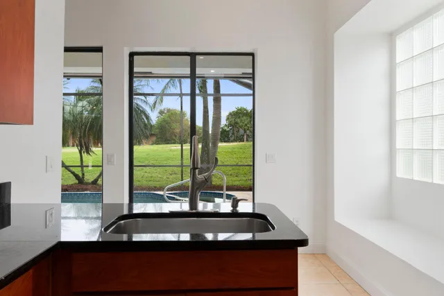 a view of a living room with a floor to ceiling window and pool table