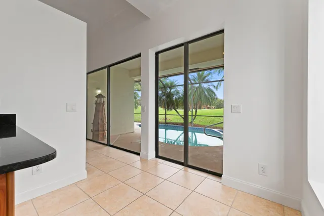 an empty room with sliding door and mountain view