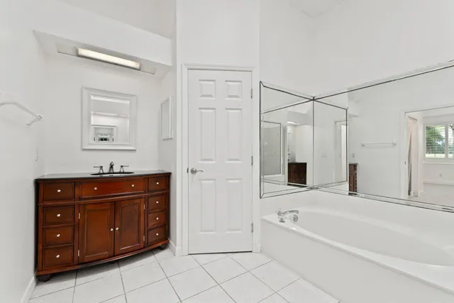 a bathroom with a glass door shower and a sink