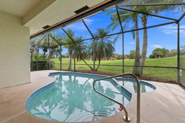 a view of a living room with a floor to ceiling window and wooden floor
