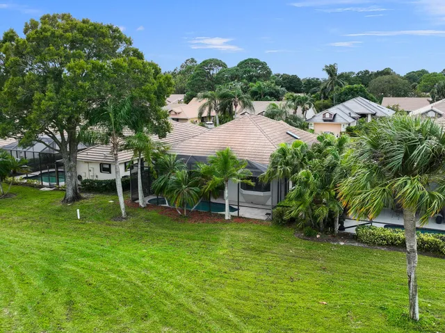 an aerial view of a house with a swimming pool yard and mountain view in back