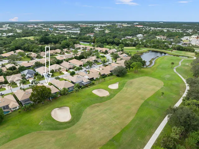 a view of a house with a yard table and chairs