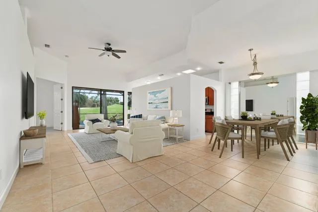 a living room with furniture a table and chairs