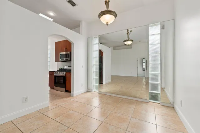 a view of a kitchen with a sink and a refrigerator