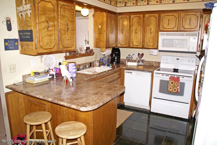 5301 Capulin Lane Amarillo, TX 79110 - Photo 11 of 18 a kitchen with stainless steel appliances granite countertop a sink stove and cabinets