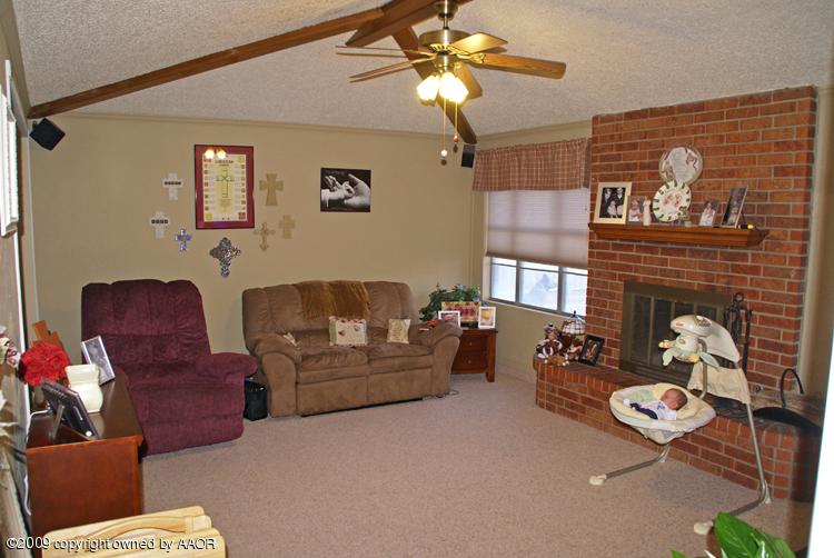 5301 Capulin Lane Amarillo, TX 79110 - Photo 6 of 18 a living room with furniture and a fireplace