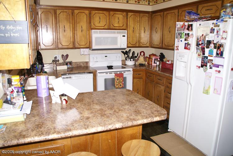 5301 Capulin Lane Amarillo, TX 79110 - Photo 9 of 18 a kitchen with refrigerator and window