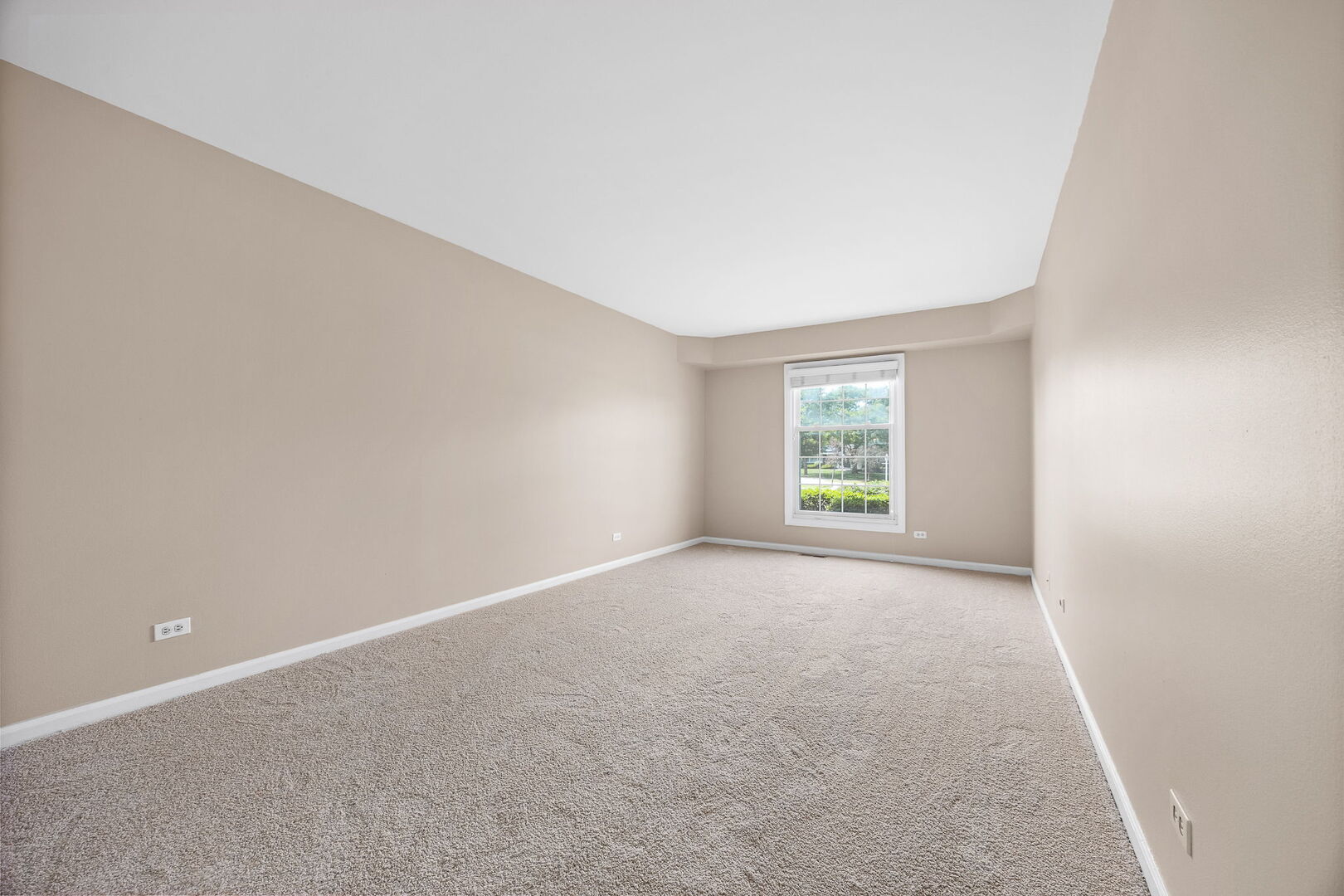 124 Carriage Way Drive, Unit B109 Burr Ridge, IL 60527 - Photo 17 of 31 an empty room with windows