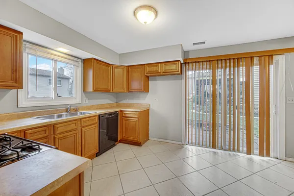 a kitchen with a stove a sink and a refrigerator