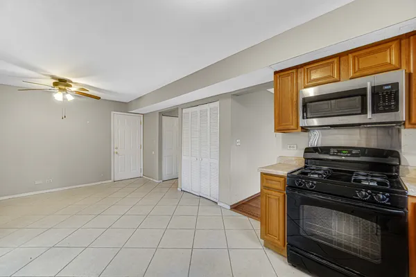 a kitchen with granite countertop a stove and a microwave
