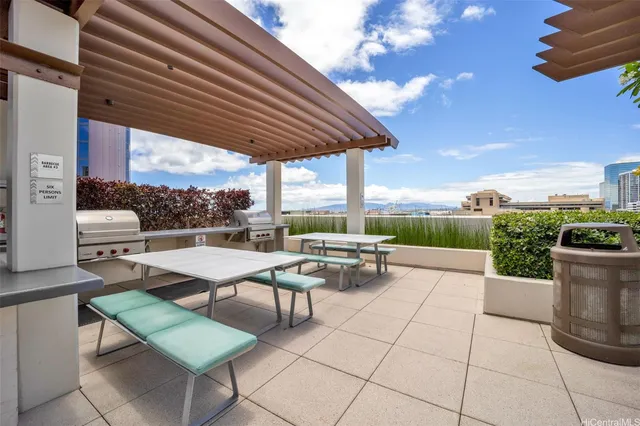 a view of a patio with a table and chairs under an umbrella