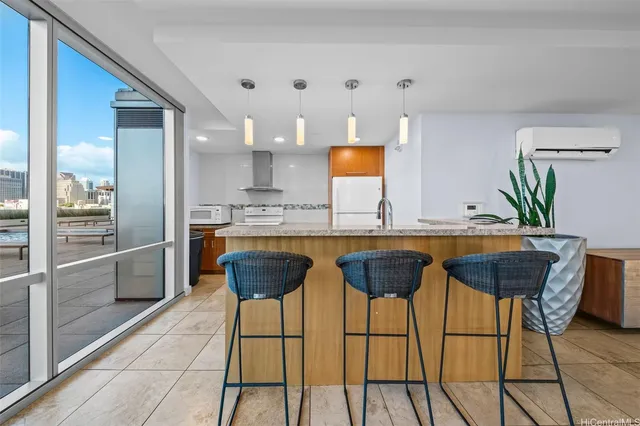 a kitchen with stainless steel appliances kitchen island granite countertop a table chairs in it and wooden floor