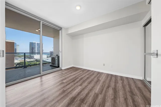 a view of empty room with wooden floor