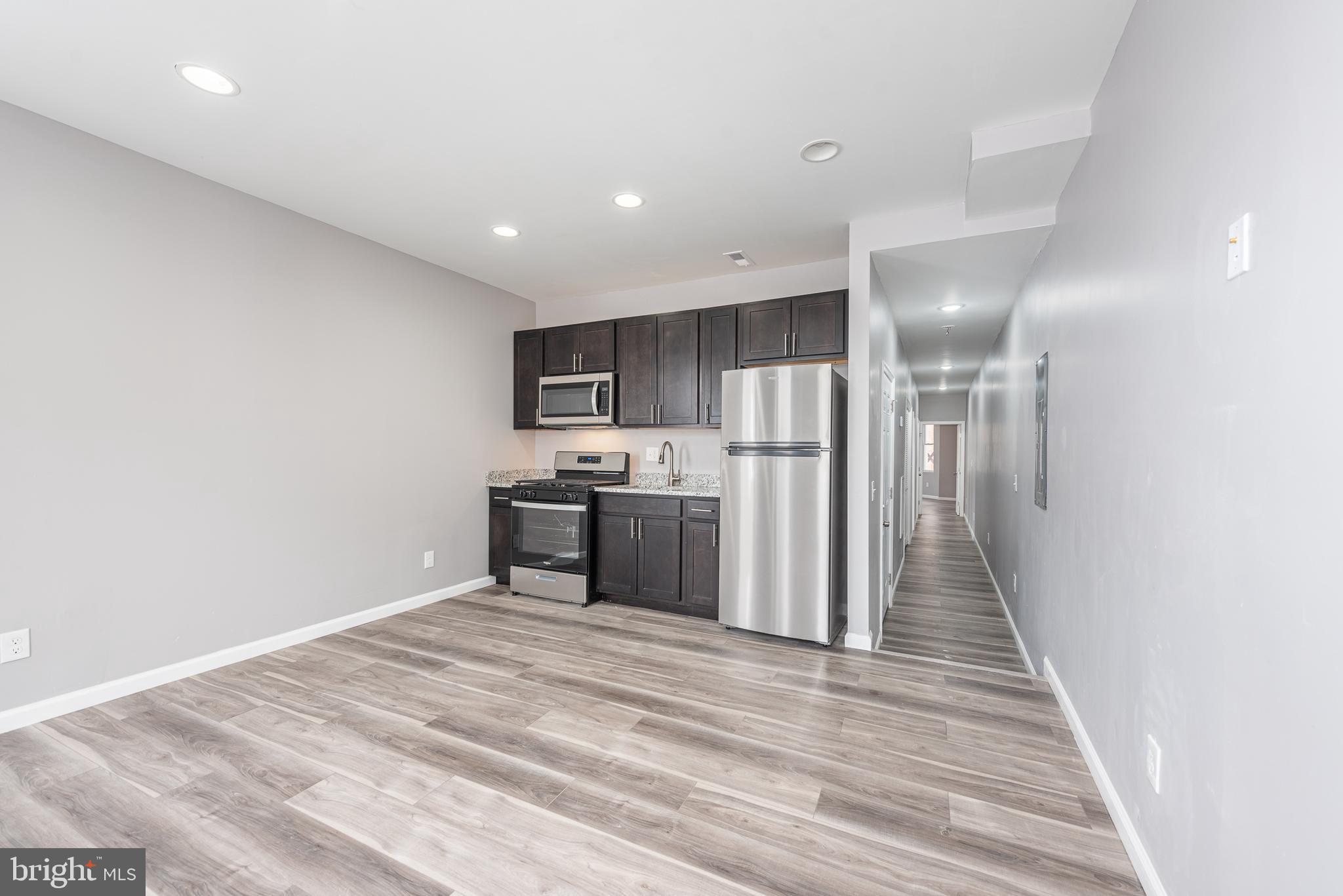 a kitchen with stainless steel appliances a refrigerator and a stove top oven