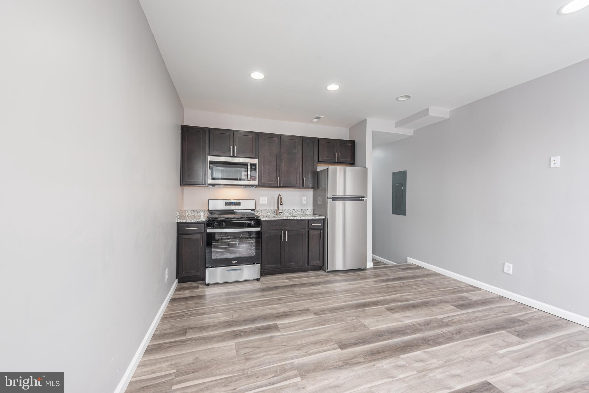 2143 Druid Hill Avenue, Unit 2 Baltimore, MD 21217 - Photo 2 of 20 a kitchen with stainless steel appliances granite countertop a refrigerator and a stove