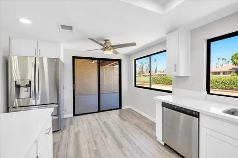 a view of a refrigerator in kitchen and wooden floor