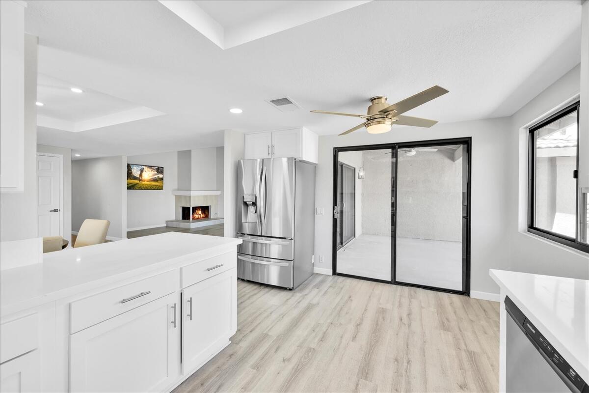 49 Maximo Way Palm Desert, CA 92260 - Photo 14 of 33 a kitchen with a refrigerator a sink and cabinets