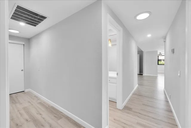 a view of a hallway with wooden floor
