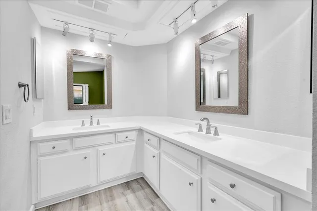 a bathroom with a double vanity sink and mirror