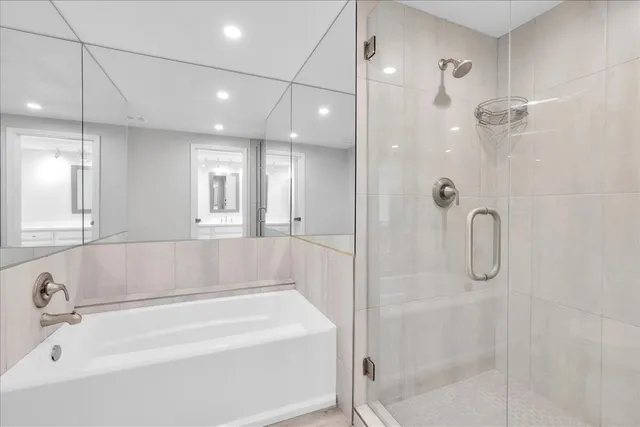 a bathroom with a bathtub and shower