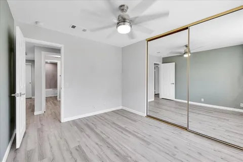 a view of an empty room with wooden floor