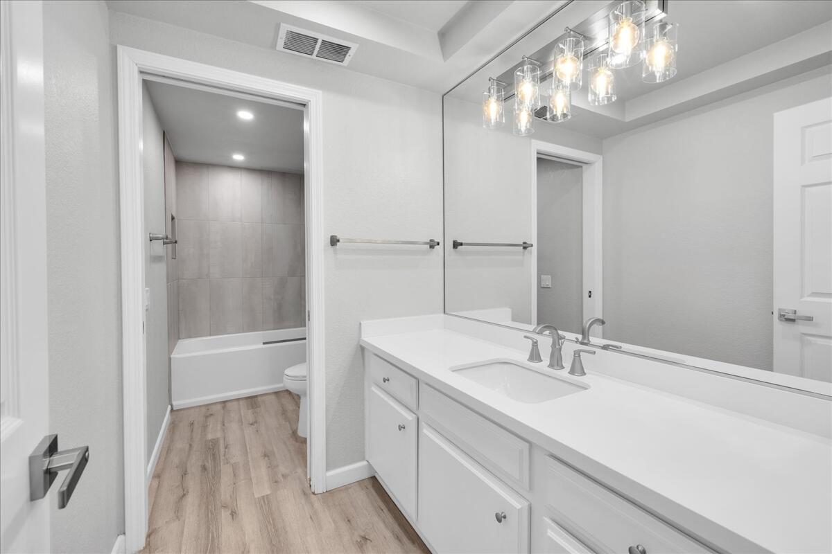 49 Maximo Way Palm Desert, CA 92260 - Photo 22 of 33 a bathroom with a sink a large mirror and shower