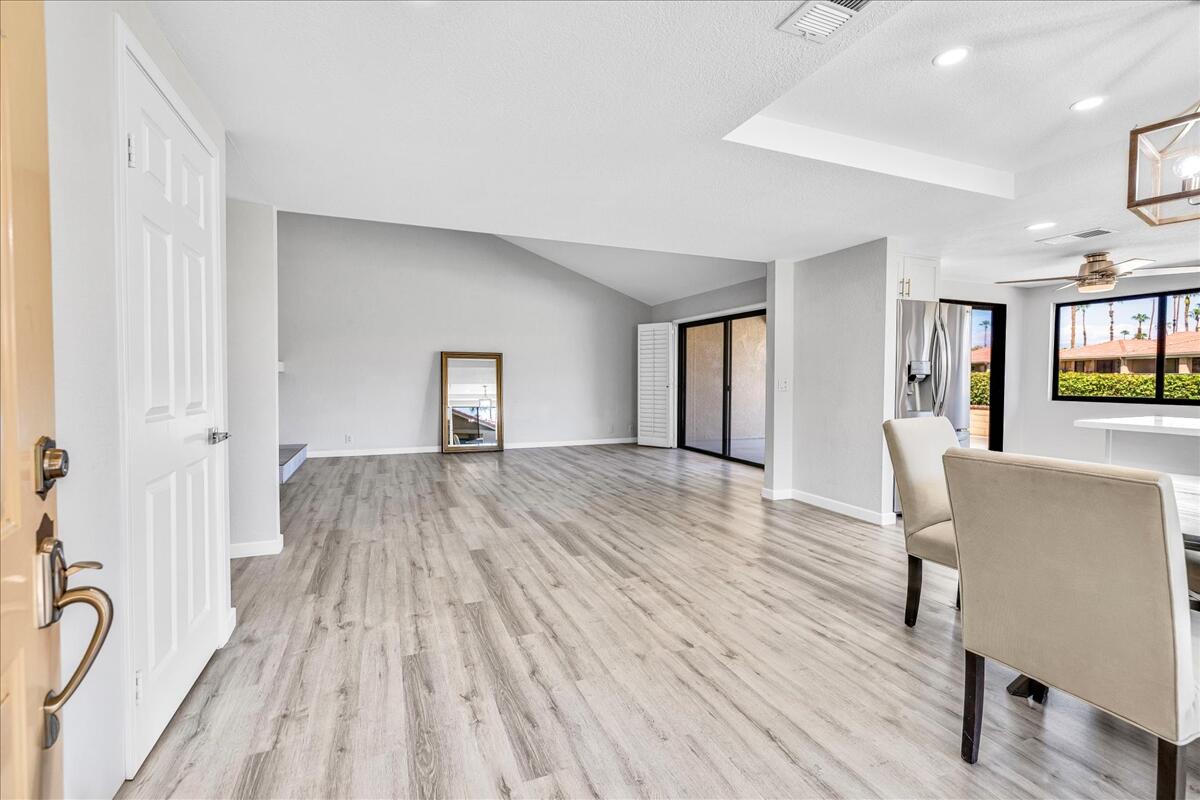 49 Maximo Way Palm Desert, CA 92260 - Photo 3 of 33 a room with wooden floor and windows