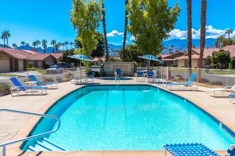 a swimming pool with outdoor seating and yard
