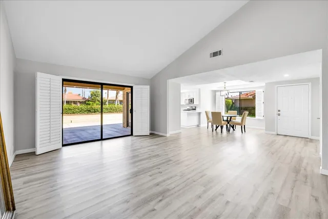 a view of dining room with wooden floor and furniture
