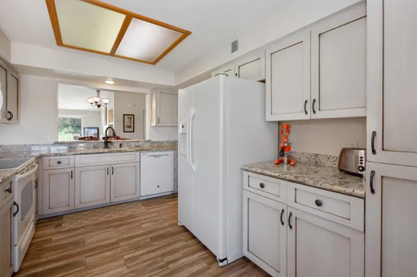 a kitchen with cabinets appliances and a counter space