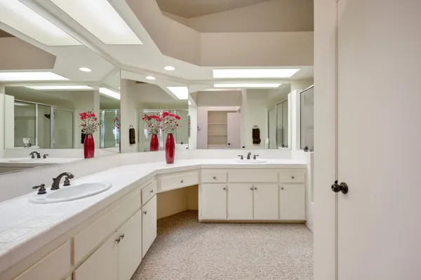 a spacious bathroom with a granite countertop sink a mirror and a