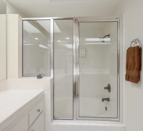 a bathroom with a shower sink and mirror