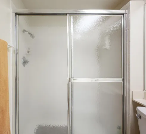 a bathroom with a glass shower door