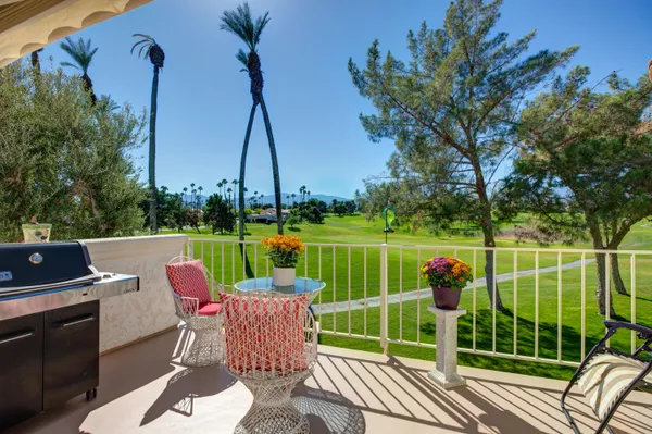 a view of a chairs and table in the patio