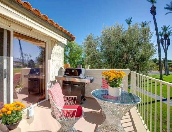 a view of a chairs and table in the balcony