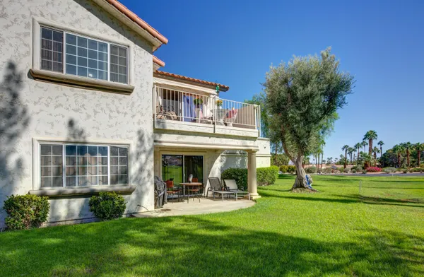 a view of house with a backyard